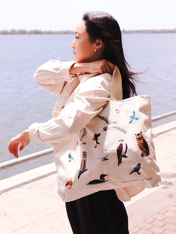 wide beige bag with illustrations of the provincial birds of canada