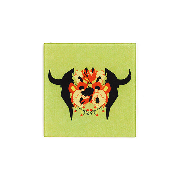 green trivet with black bison skull; red flowers emerging from skull silhouette