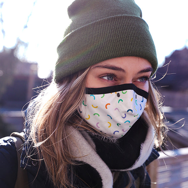 person with green beanie wearing macaroni mask