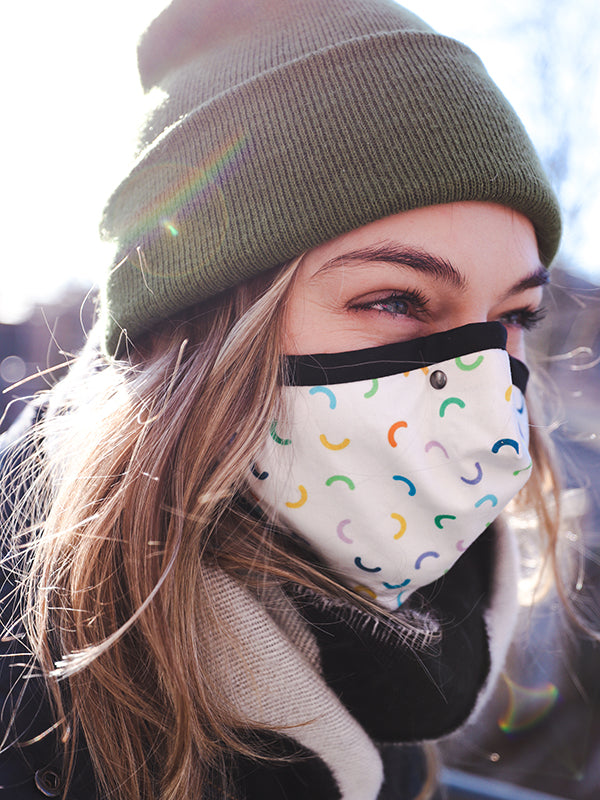 person with green beanie wearing macaroni mask