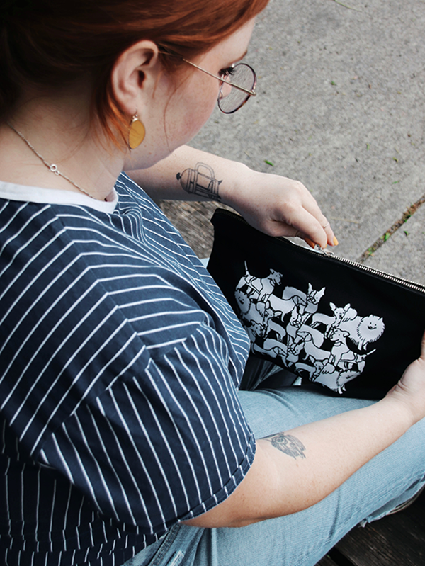 back of a girl opening the zip case with dog illustration pattern