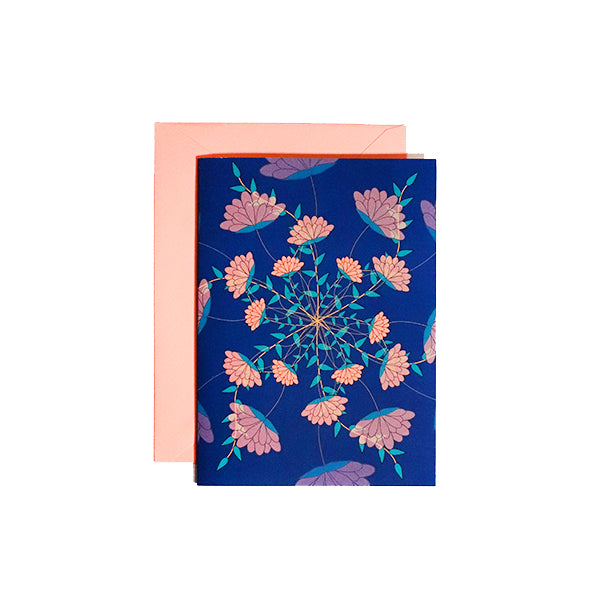card with illustration of several pink flowers spiralling out from the middle. Pink envelope behind card