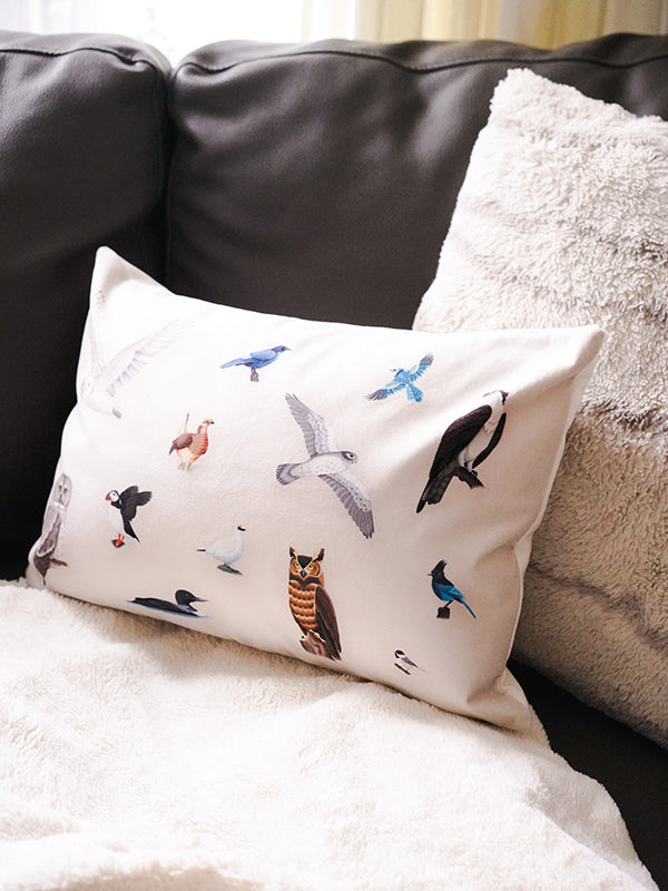 beige pillow with illustrations of the provincial birds of canada