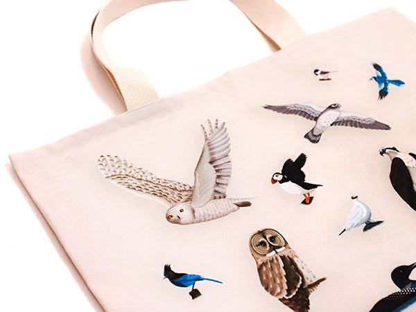 wide beige bag with illustrations of the provincial birds of canada