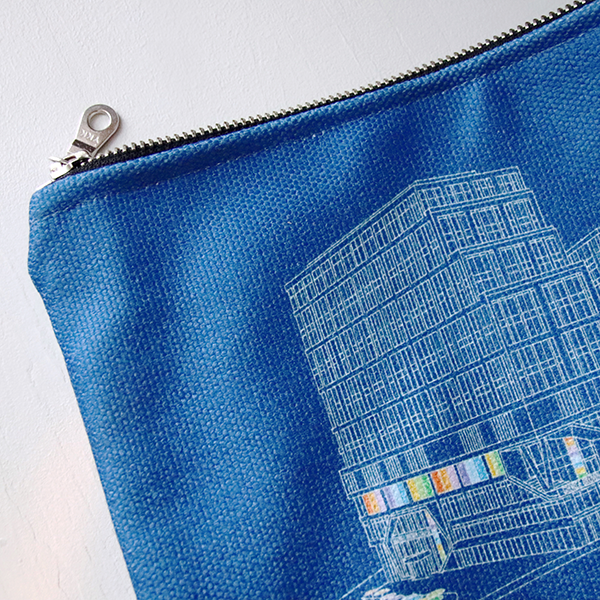 10" x 7.5" blue canvas zip pouch with george brown daniels building illustration on front in white