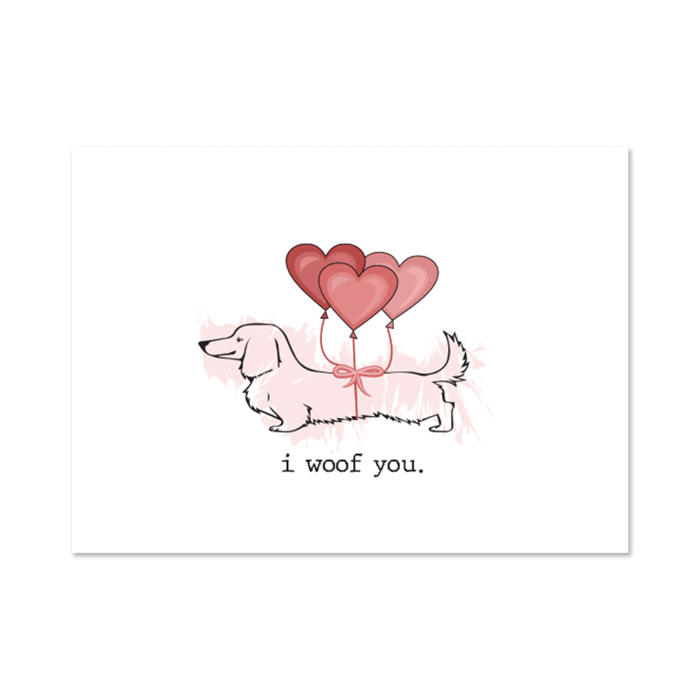 4.5" x 6.25" valentines day card in white with an illustration of a dachshund with three heart balloons attached to it and i woof you text