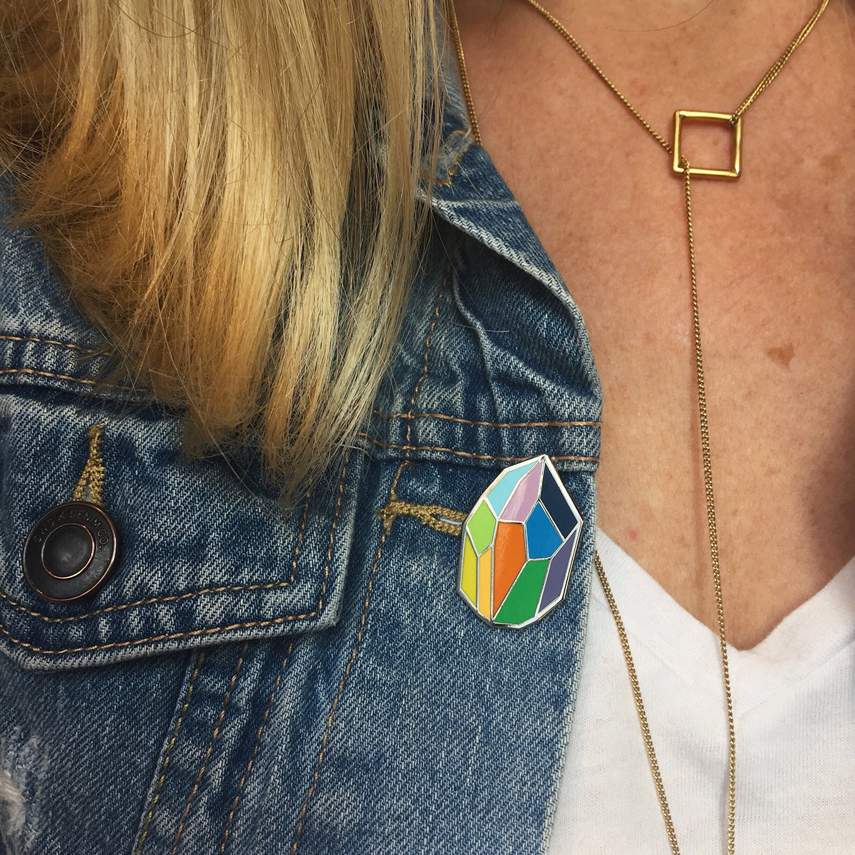 woman wearing geode enamel pin with george brown colours