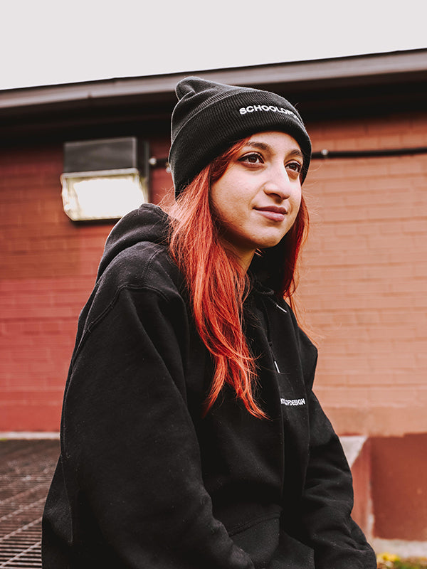 Person with red hair wearing black SOD hoodie and black SOD toque.