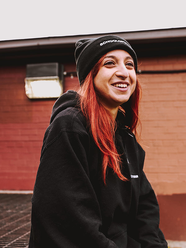 Person with red hair wearing black SOD hoodie and black SOD toque.