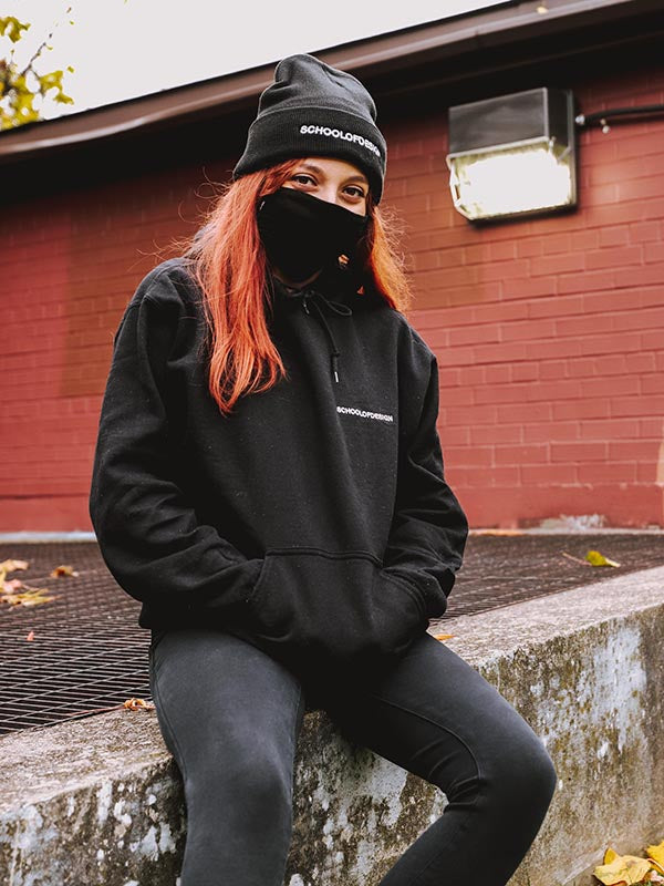 Person with red hair wearing black SOD hoodie, mask, and toque