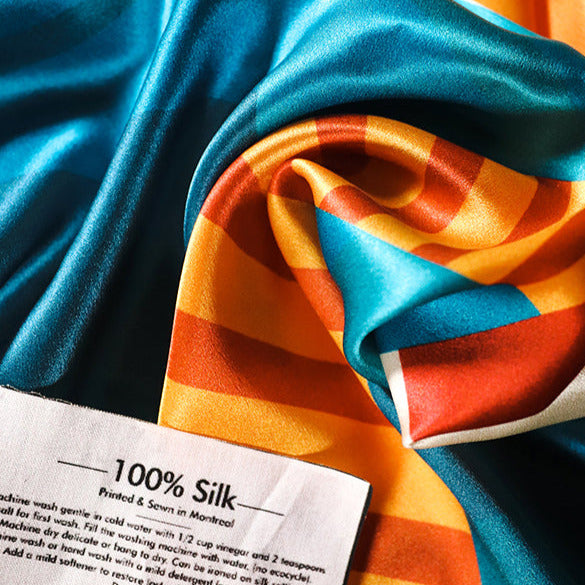 Silk bandana featuring lighthouse, sunset, and path through blue water. Note reading 100% silk