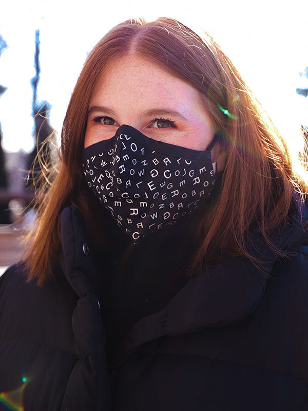 person wearing typography mask