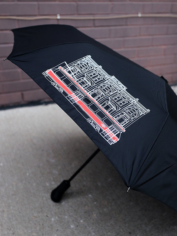 black umbrella with toronto street car illustration in white and red