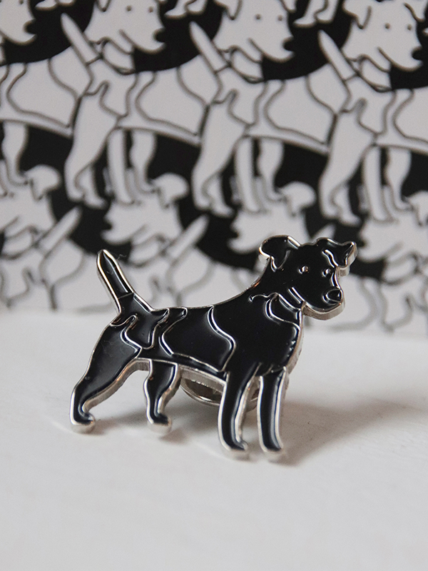 close up of black dog enamel pin